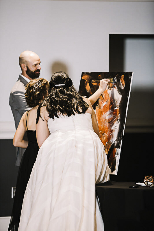 bride-and-groom-and-daughter-unity-ceremony-at-the-zoo-with-paint