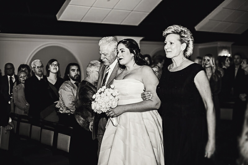 bride-and-her-mom-and-dad-walking-down-the-aisle-at-malawi-toledo-zoo-ceremony