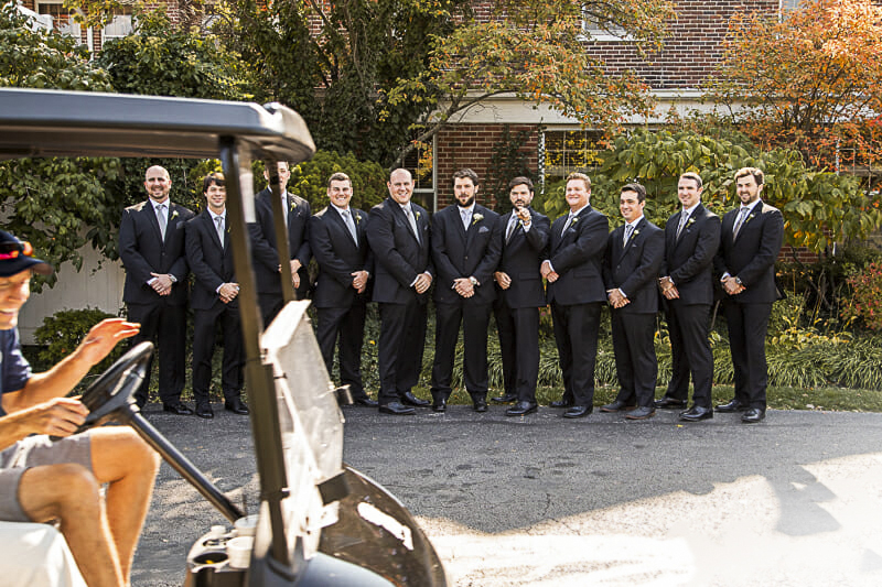 golf-cart-driving-through-groomsmen-photo