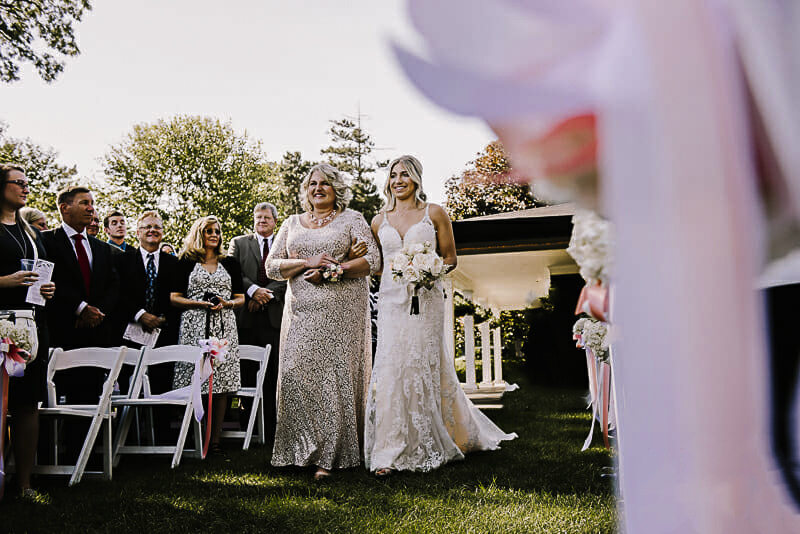 bride-and-her-mom-walking-down-the-aisle-at-toledo-country-club