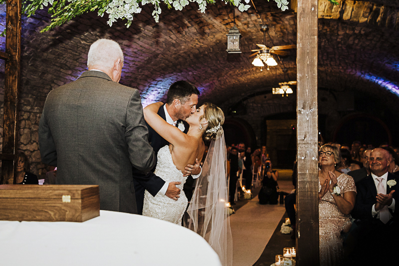 first-kiss-at-gideon-owen-wine-cellar-wedding-ceremony