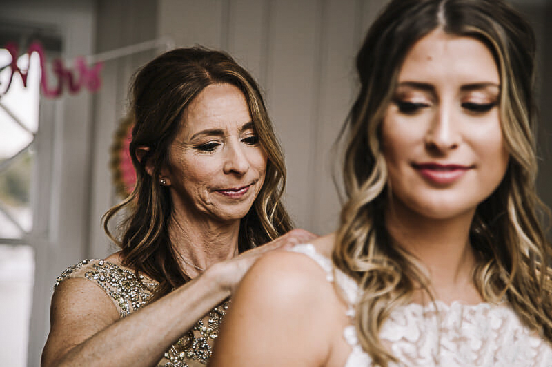 mom-helping-bride-get-into-belle-amour-dress