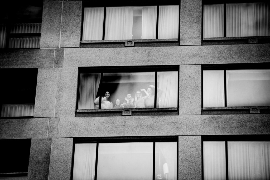 bridesmaids posing and looking out window toledo wedding