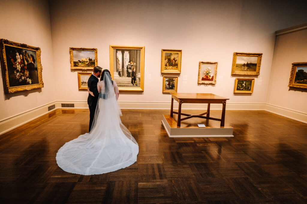 wedding couple looking at a painting at the toledo museum of art